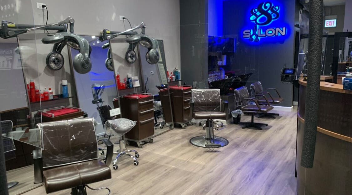 Modern styling chairs at Le Salon & Spa in Chicago, Illinois, US under soft lighting.