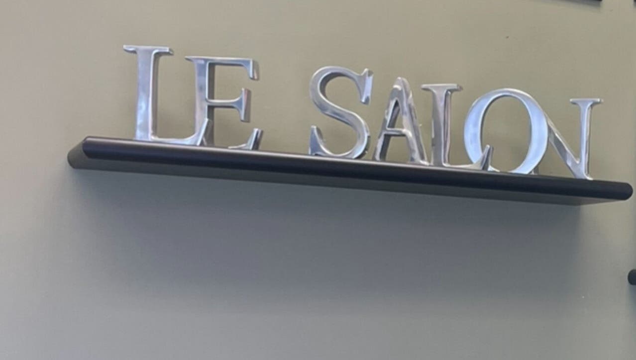 Elegant Le Salon & Spa sign on display shelf in Chicago, Illinois, US.