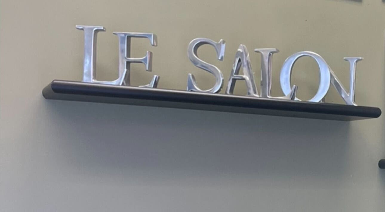 Elegant Le Salon & Spa sign on display shelf in Chicago, Illinois, US.