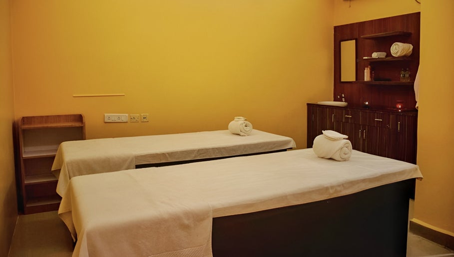 Relaxing massage room at Elanza de Look Unisex Salon & Spa in Bogmalo, Goa, IN featuring two treatment tables.