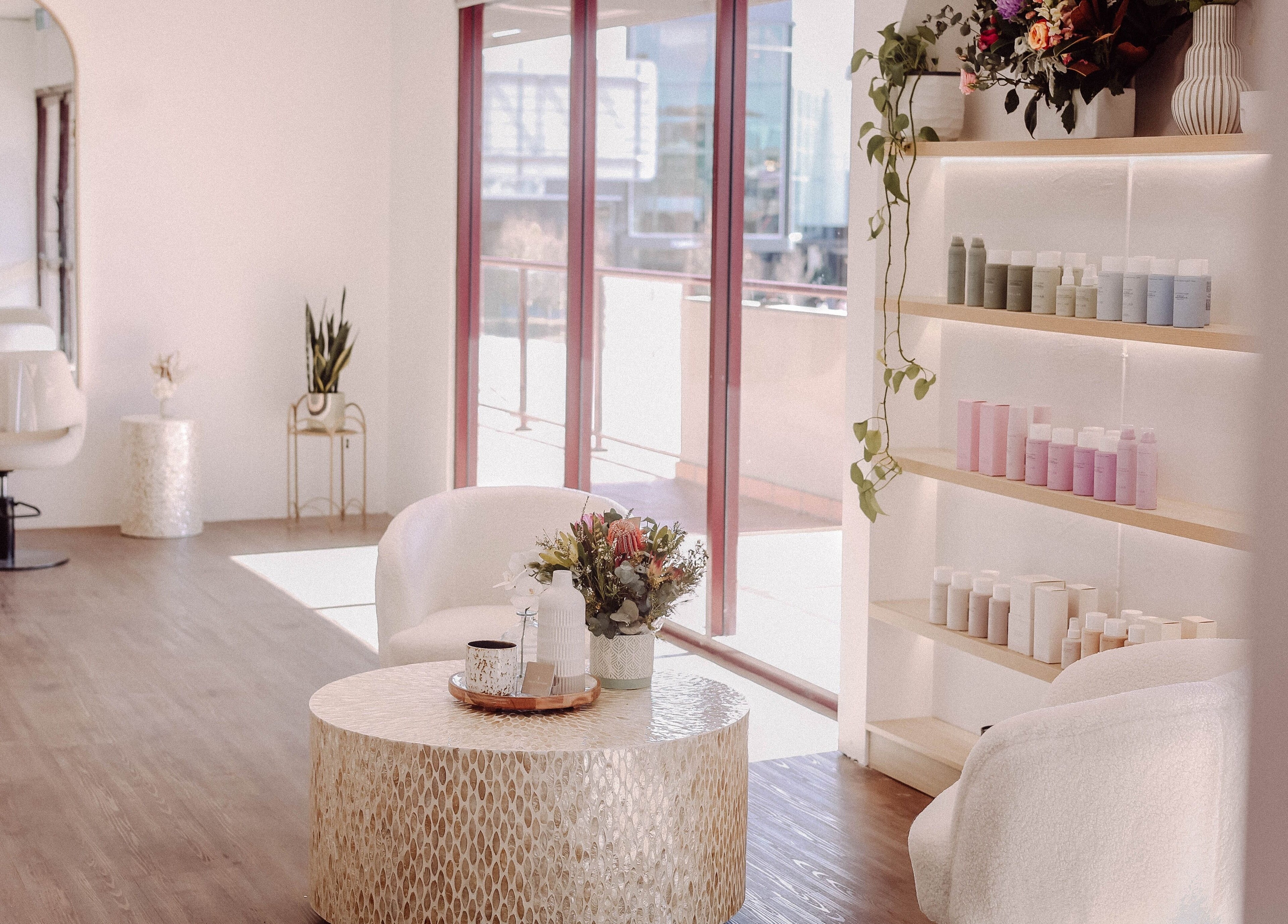 Elegant interior of Hair and the Fiddle in Narellan, New South Wales, AU, showcasing salon chairs and product display.