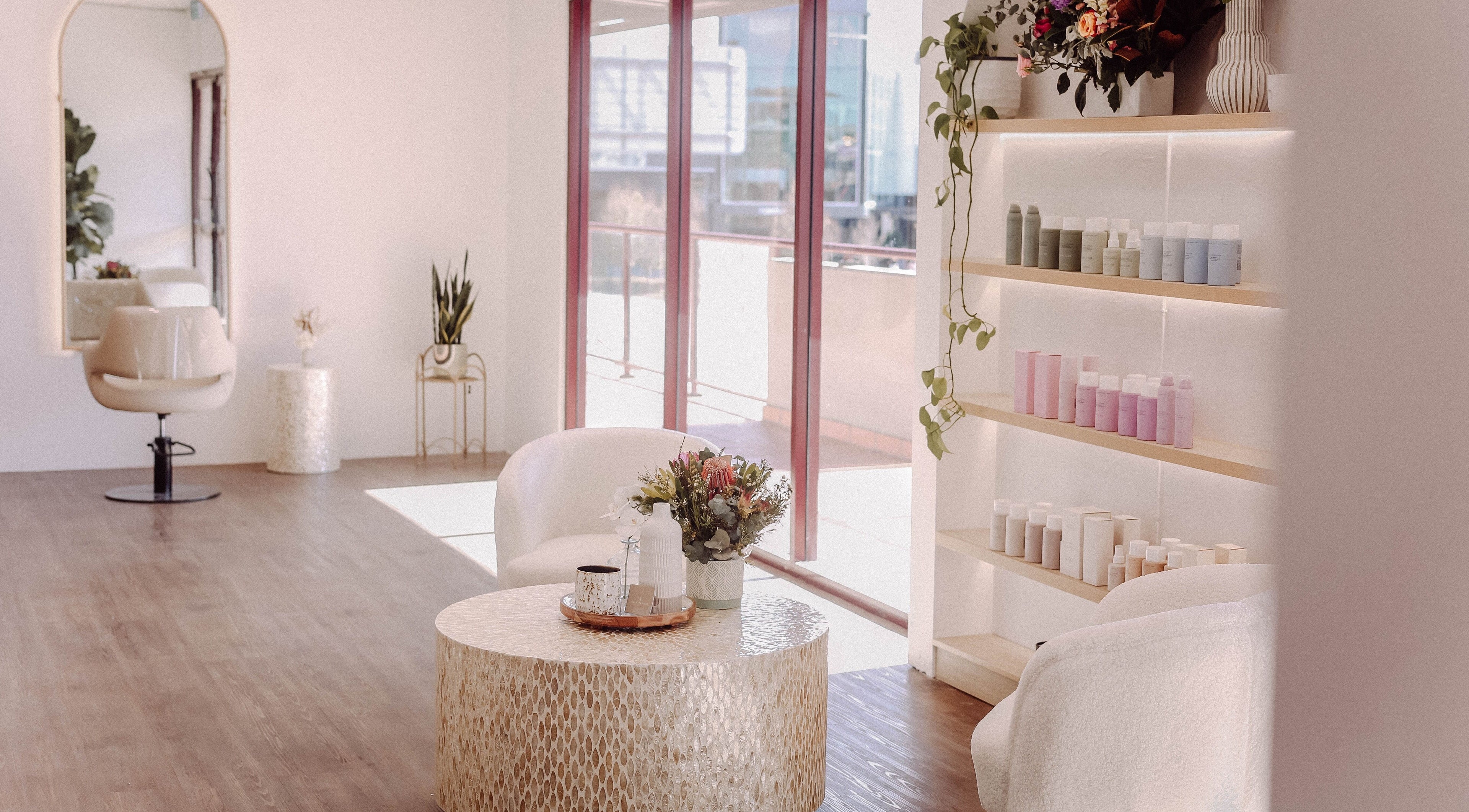 Elegant interior of Hair and the Fiddle in Narellan, New South Wales, AU, showcasing salon chairs and product display.