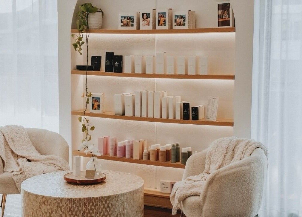 Inviting lounge at Hair and the Fiddle, Narellan, New South Wales, AU with comfy chairs and elegant shelves.