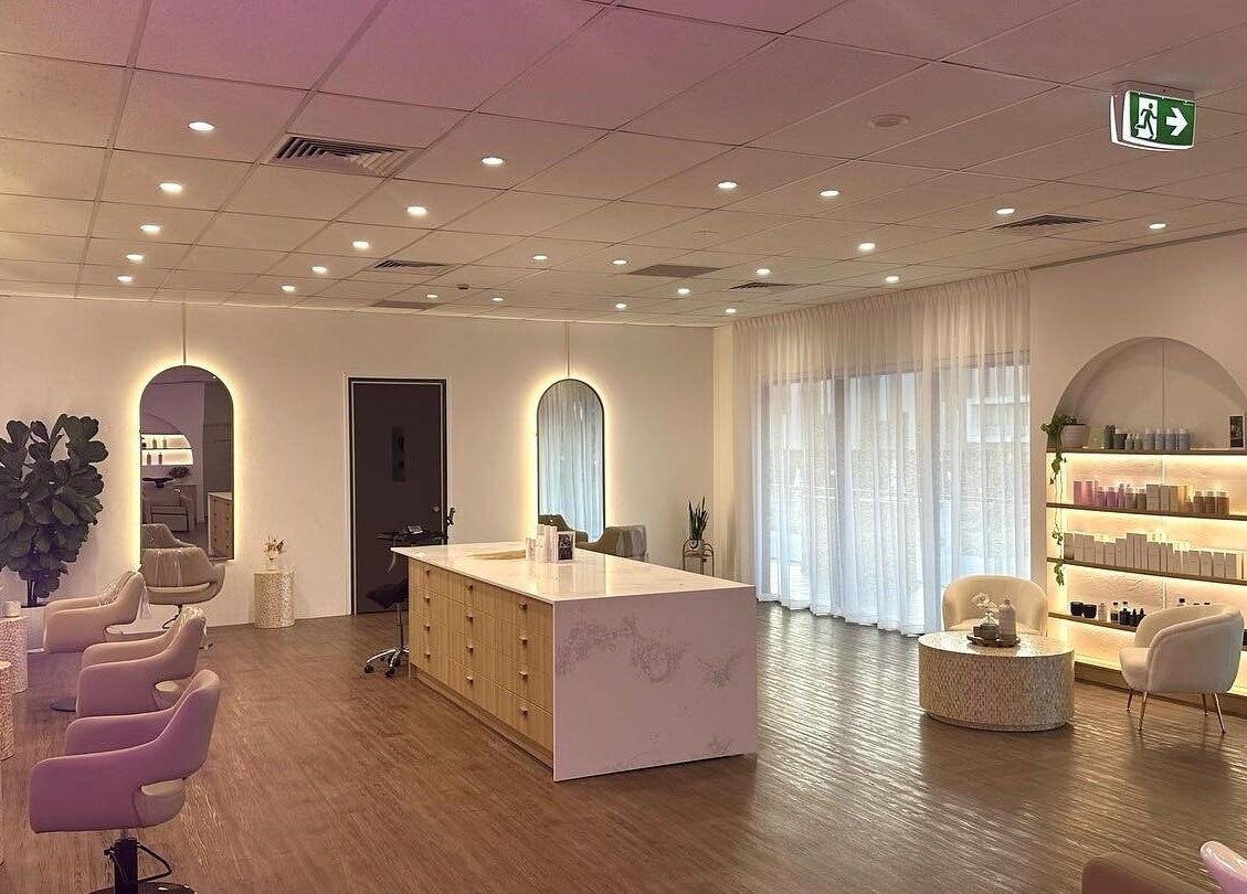 Elegant interior of Hair and the Fiddle in Narellan, New South Wales, AU with modern styling chairs and decor.