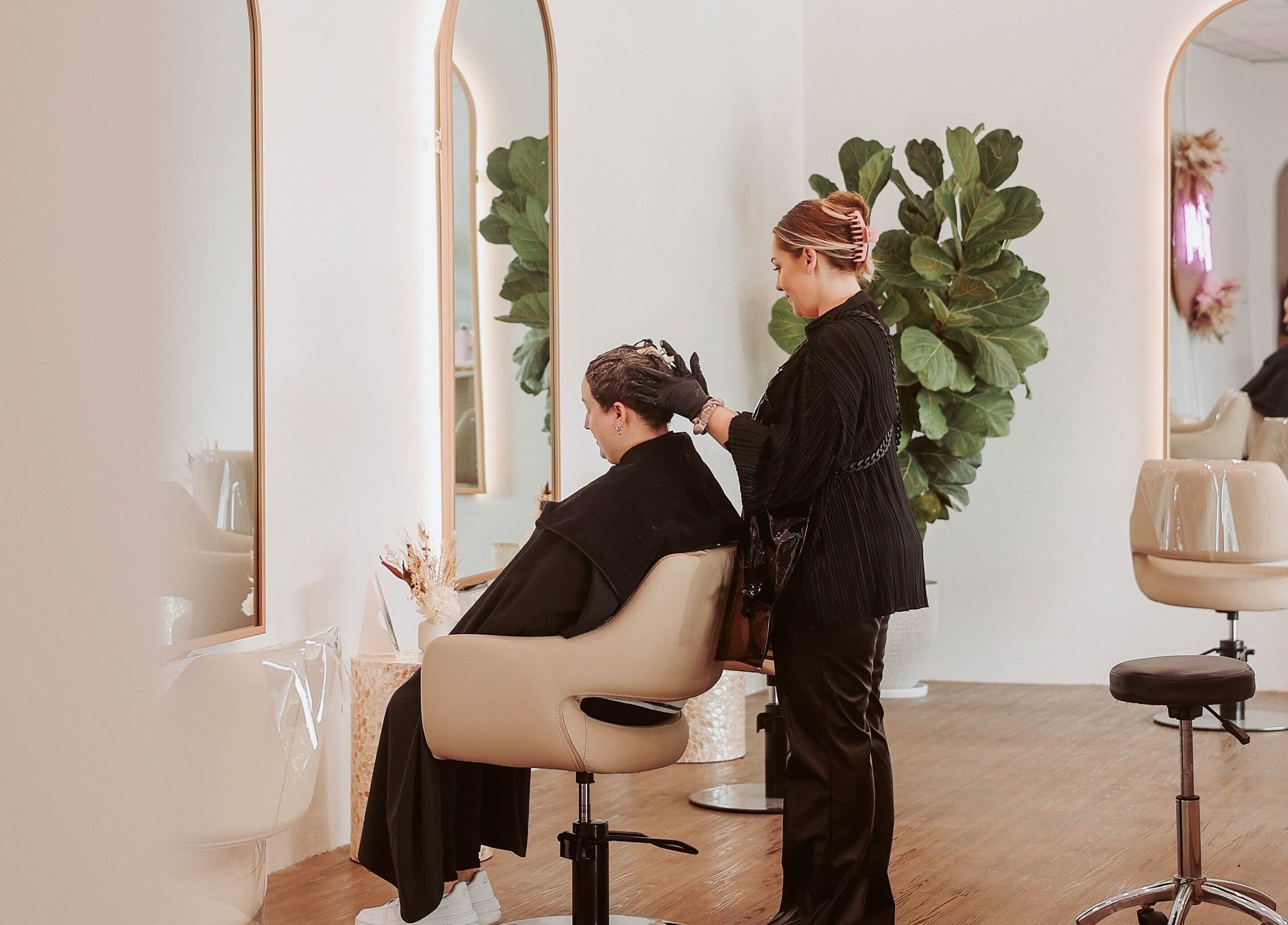 Hairdresser styling client at Hair and the Fiddle, Narellan, New South Wales, AU.