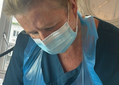 Professional at Ml Aesthetics in Birmingham, England, GB provides expert care wearing a mask and apron.