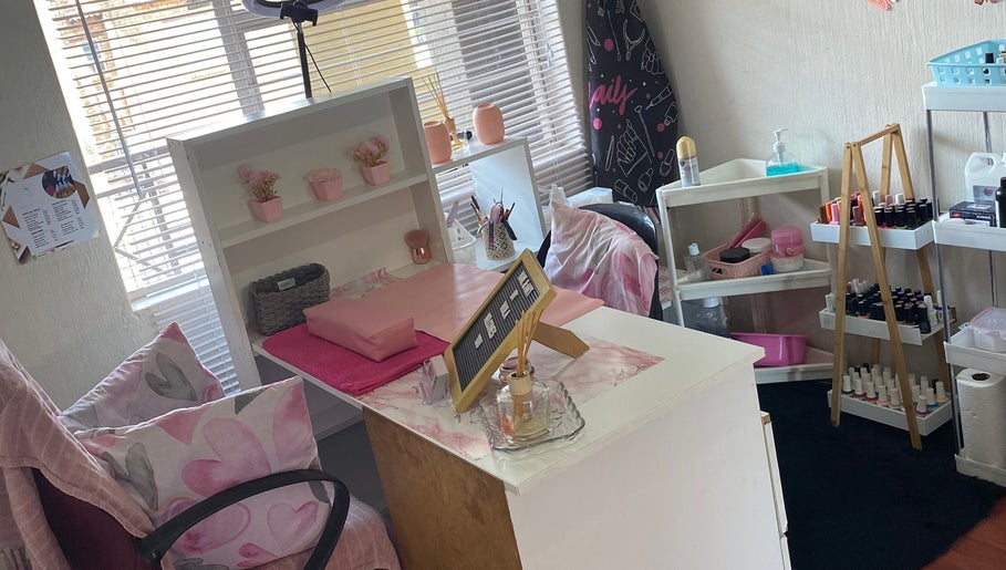Cozy nail station at Nail and Art, Midrand, Gauteng, ZA with pink decor, shelves, and nail polish display.