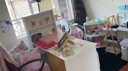Cozy nail station at Nail and Art, Midrand, Gauteng, ZA with pink decor, shelves, and nail polish display.