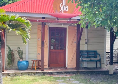 Welcoming entrance of TI SPA in Grand Case, Collectivité De Saint-martin, MF with lush greenery.