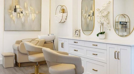 Luxurious salon interior at Atah’s Elegance, Hamilton, Ontario, CA with chic decor and plush seating.