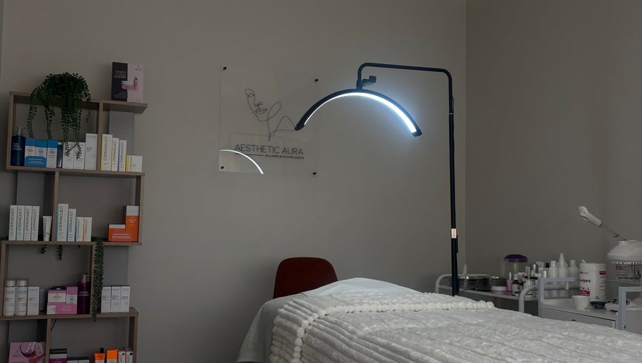 Serene treatment room at Aesthetic Aura, Randburg, Gauteng, ZA, showcasing a cozy bed and professional skincare products.