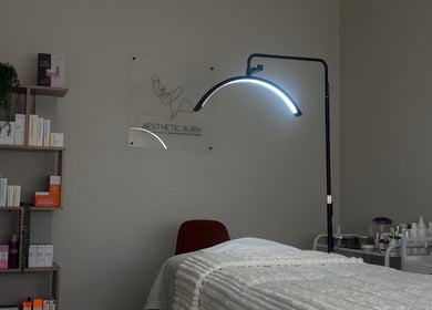 Serene treatment room at Aesthetic Aura, Randburg, Gauteng, ZA, showcasing a cozy bed and professional skincare products.