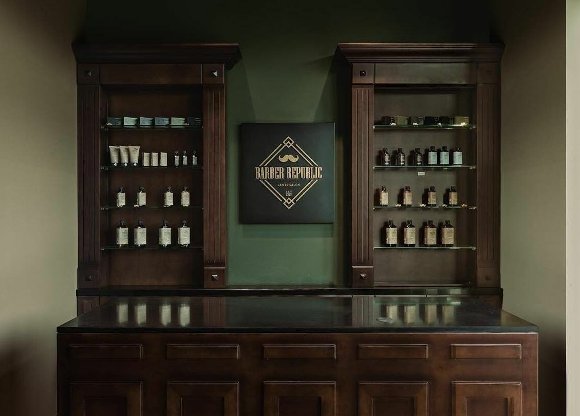 Elegant display of grooming products at Barber Republic Gents Saloon, Dubai, AE with classic wooden decor.