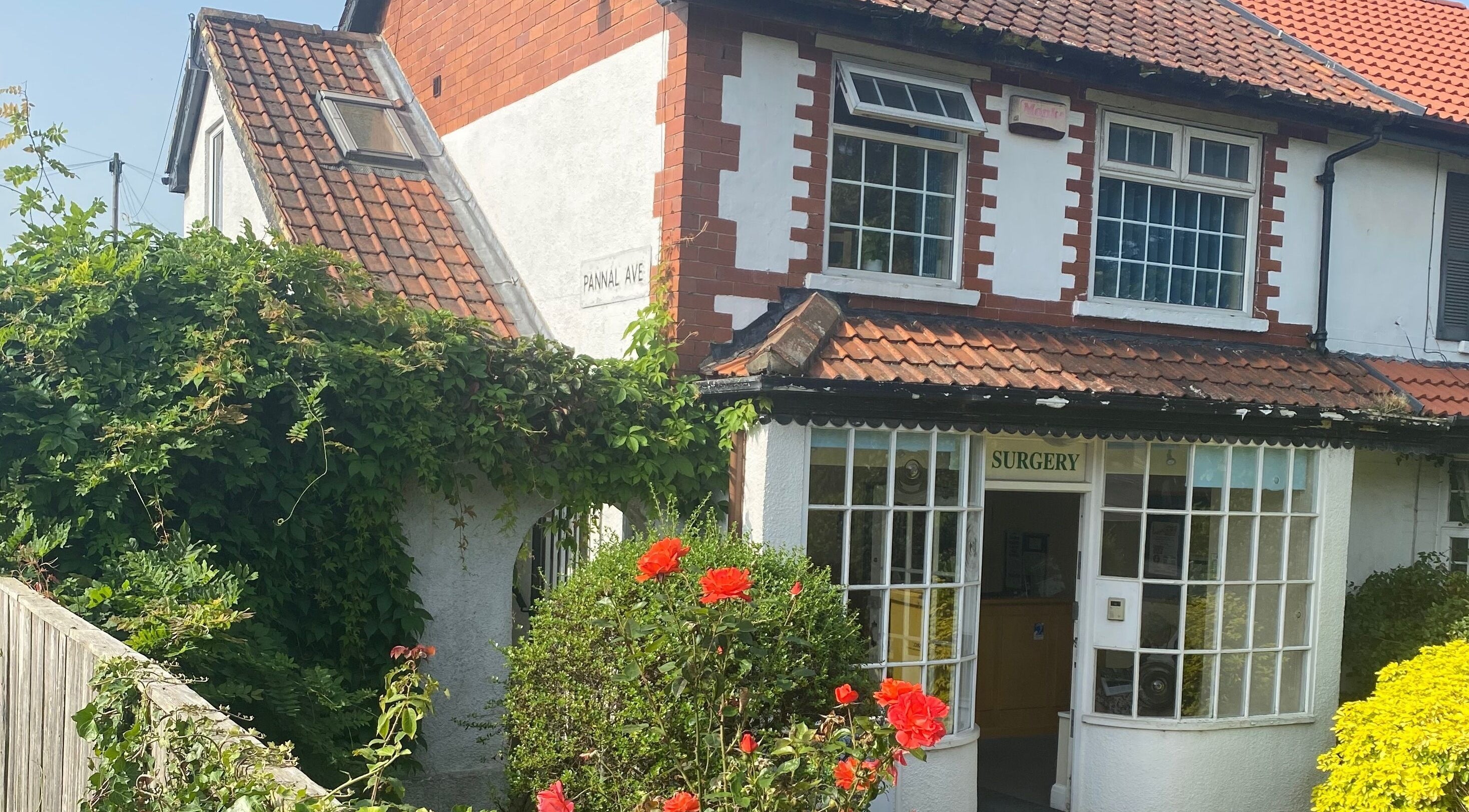 Feet Up Reflexology's quaint exterior in Harrogate, England, GB surrounded by lush greenery.
