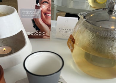 Cozy setup at Skin & Brow Collective, Peregian Springs, Queensland with tea, candle, and skincare display.