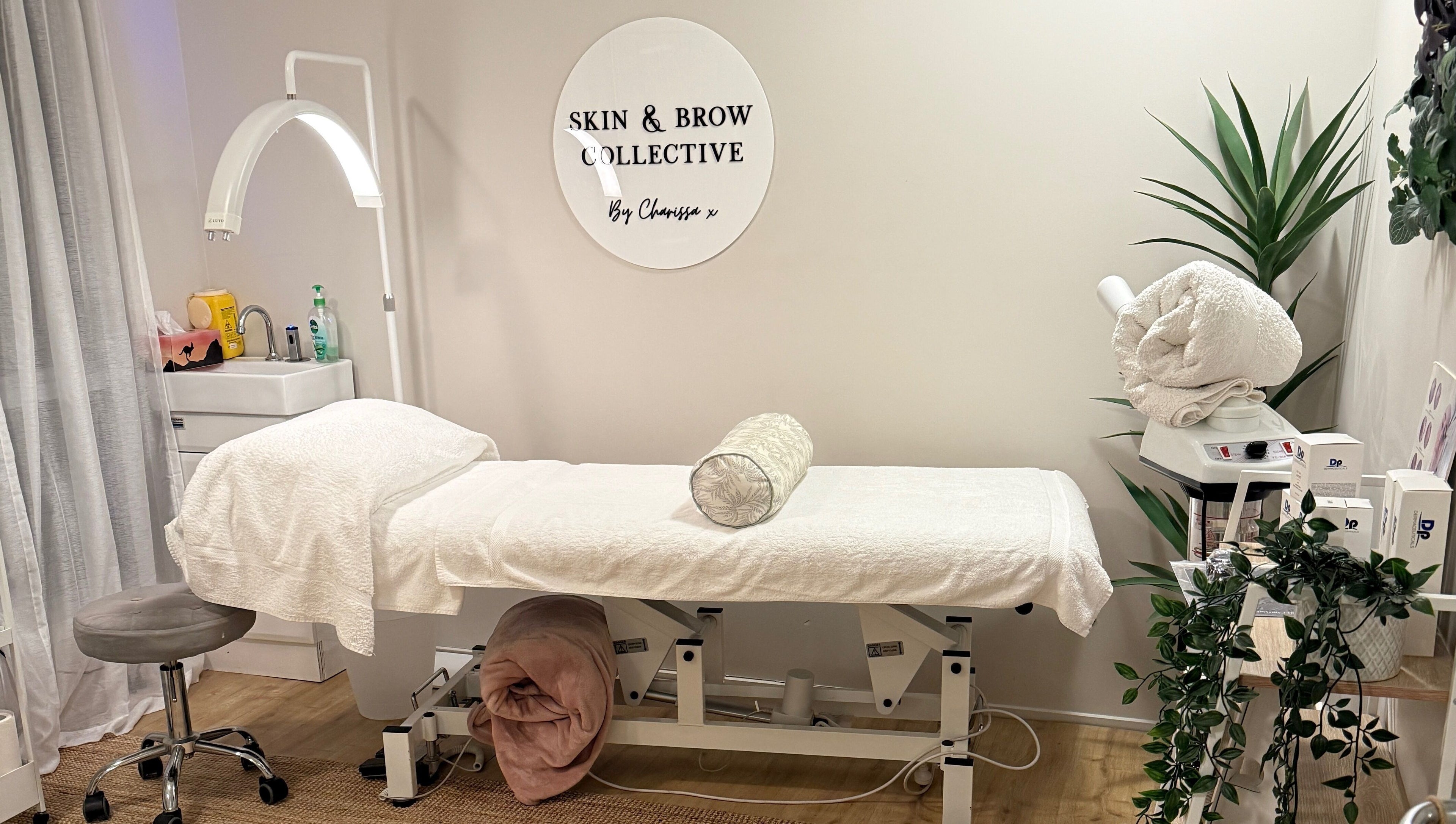 Tranquil treatment room at Skin & Brow Collective in Peregian Springs, Queensland, AU with neatly arranged decor.