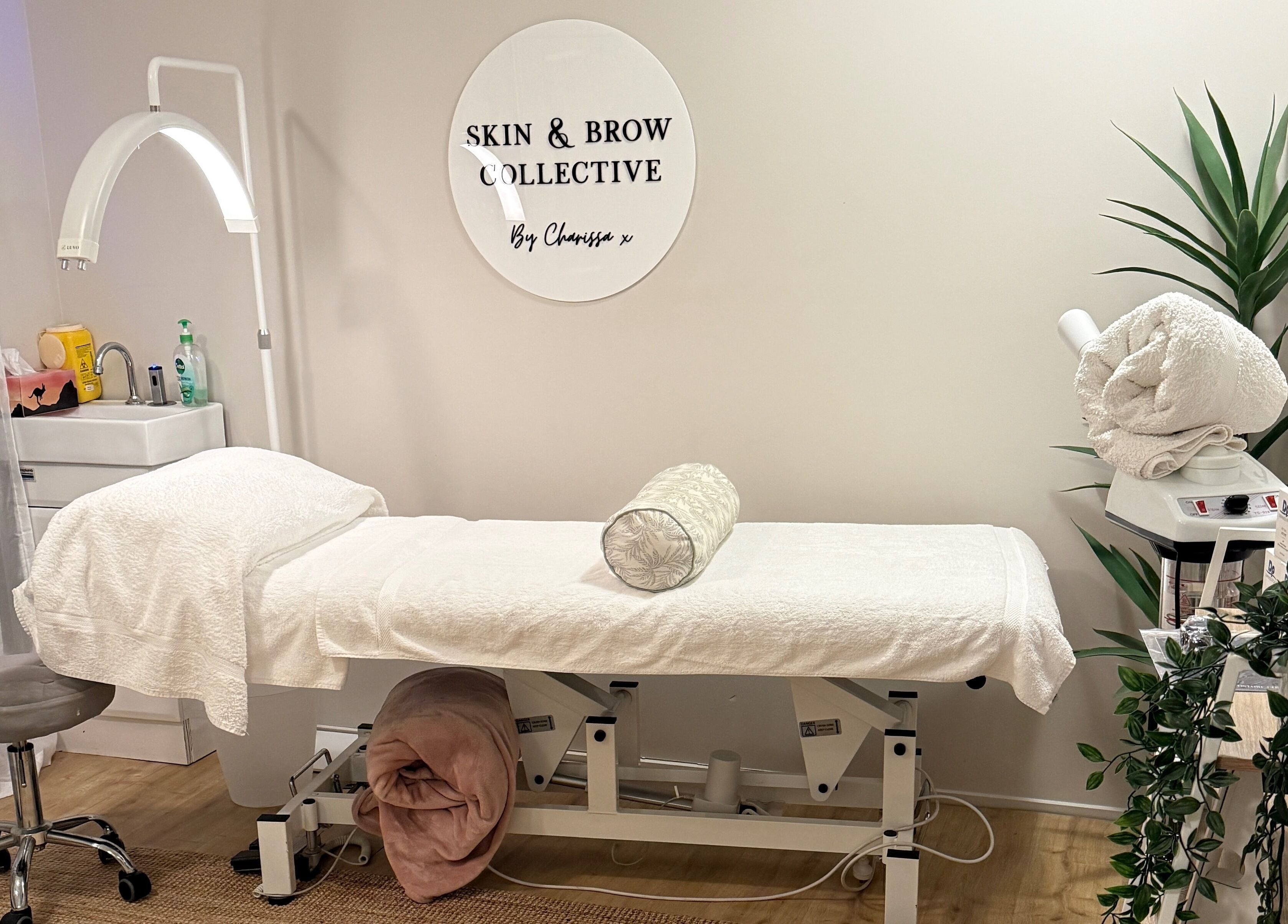 Tranquil treatment room at Skin & Brow Collective in Peregian Springs, Queensland, AU with neatly arranged decor.