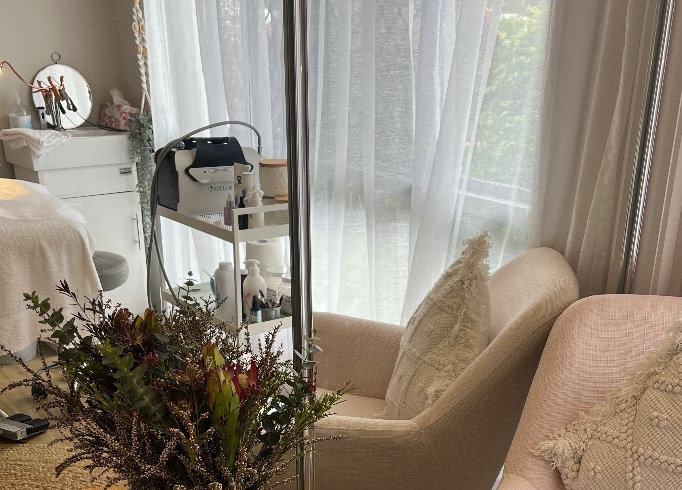 Serene spa space at Skin & Brow Collective, Peregian Springs, Queensland, AU, with cozy seating and soft lighting.