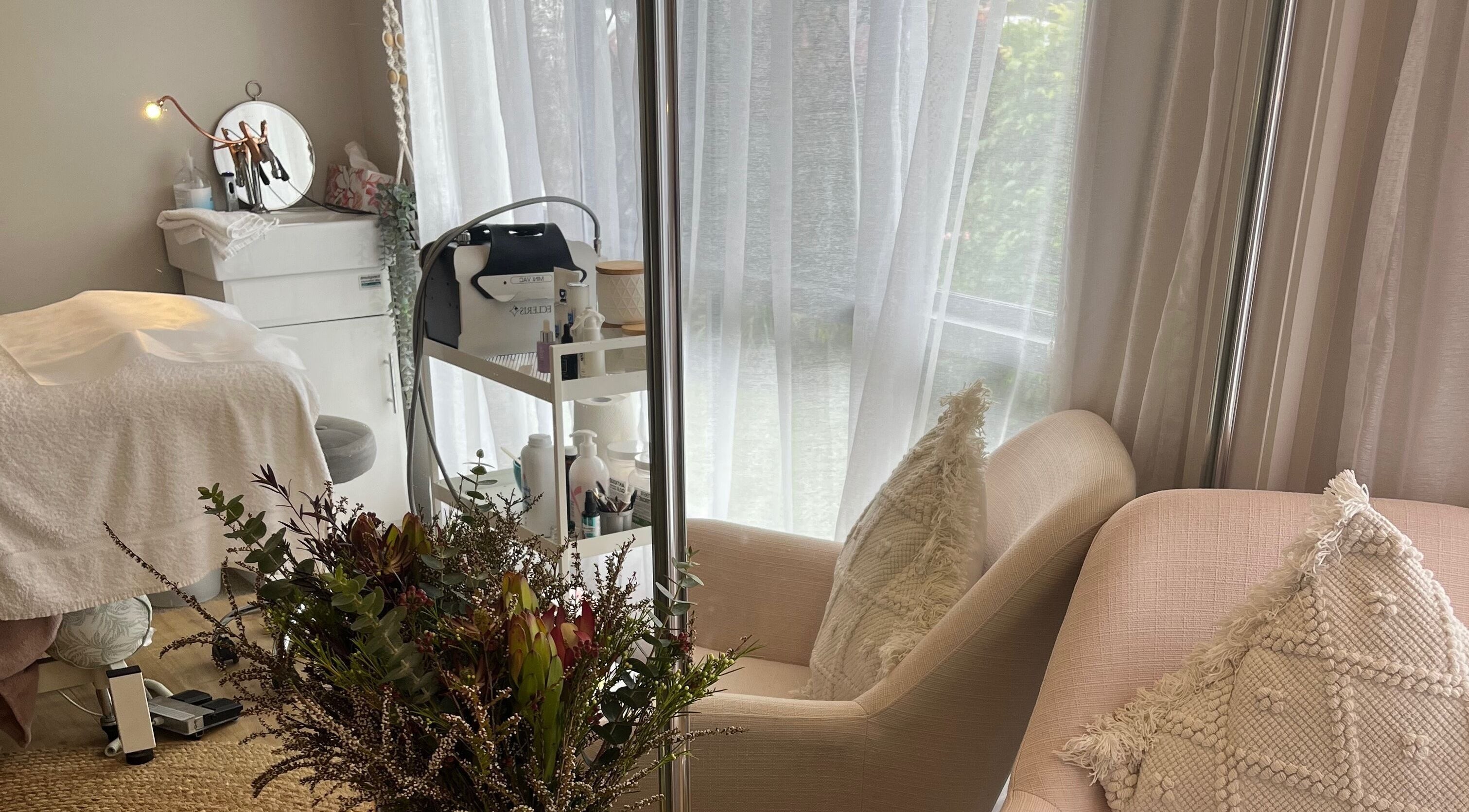 Serene spa space at Skin & Brow Collective, Peregian Springs, Queensland, AU, with cozy seating and soft lighting.