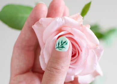 Intricate leaf nail art next to a pink rose at Beauty by Noushin, København, Denmark, DK.