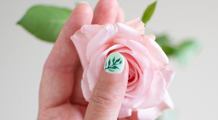 Intricate leaf nail art next to a pink rose at Beauty by Noushin, København, Denmark, DK.