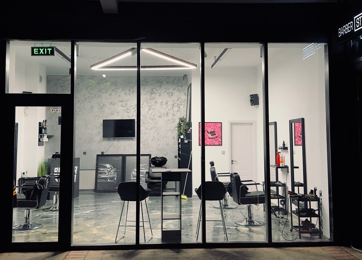 View of Barber Studio 2's chic interior through glass facade in Plovdiv, Plovdiv, BG.