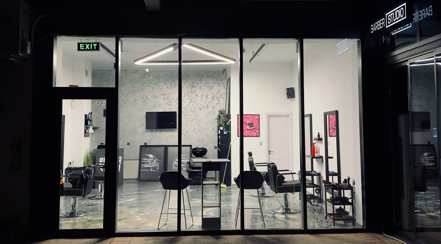 View of Barber Studio 2's chic interior through glass facade in Plovdiv, Plovdiv, BG.
