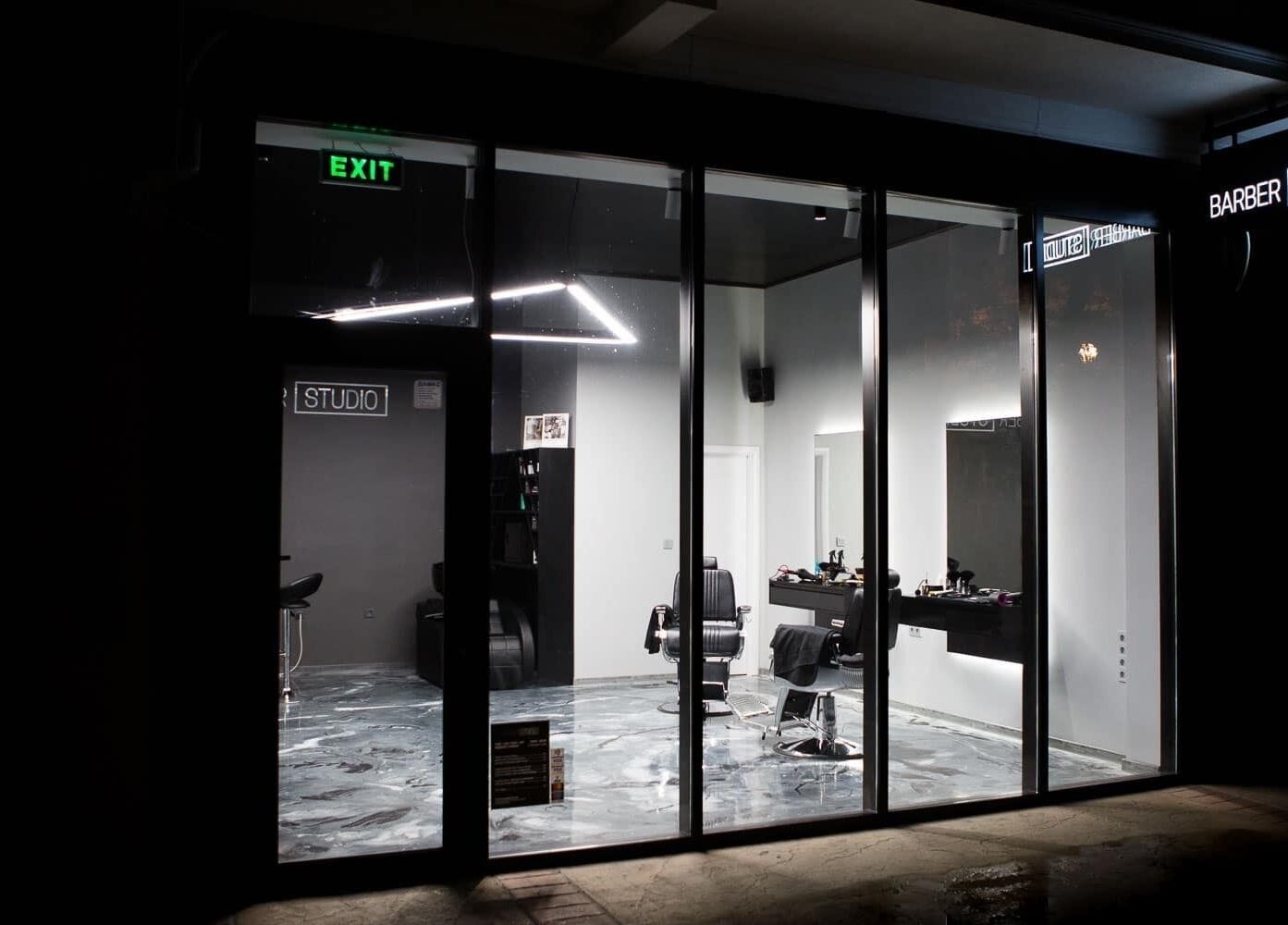 Exterior of Barber Studio 2 in Plovdiv, BG, showcasing sleek interiors through glass windows.