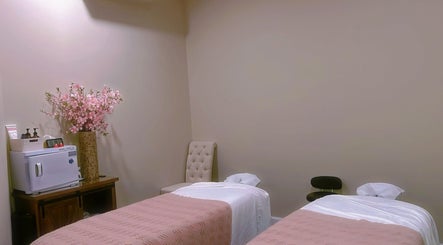Relaxing massage room at BeYoung Massage, Tysons, Virginia, US with floral decor and twin massage beds.