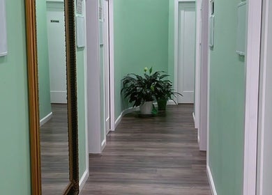 Peaceful green hallway at BeYoung Massage, Tysons, Virginia, US, featuring elegant decor and lush plants.