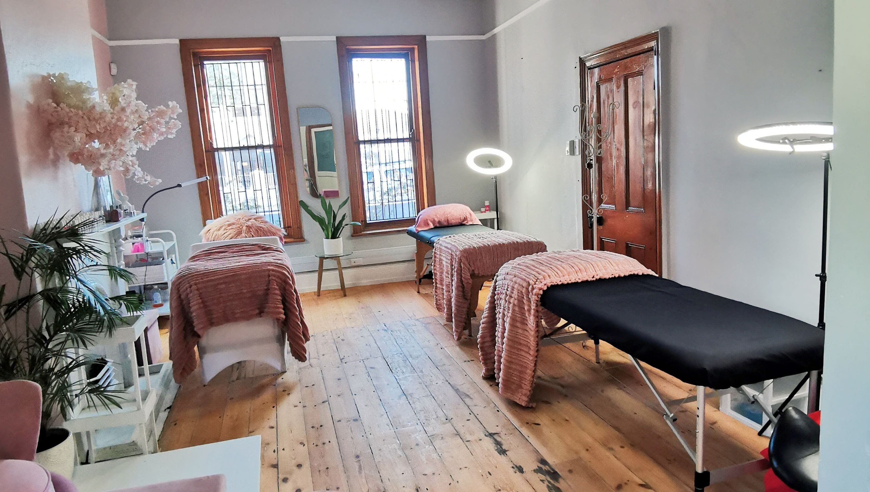 Tranquil treatment room at NovaBelle Beauty, Cape Town, Western Cape, ZA with cozy massage tables and soft lighting.