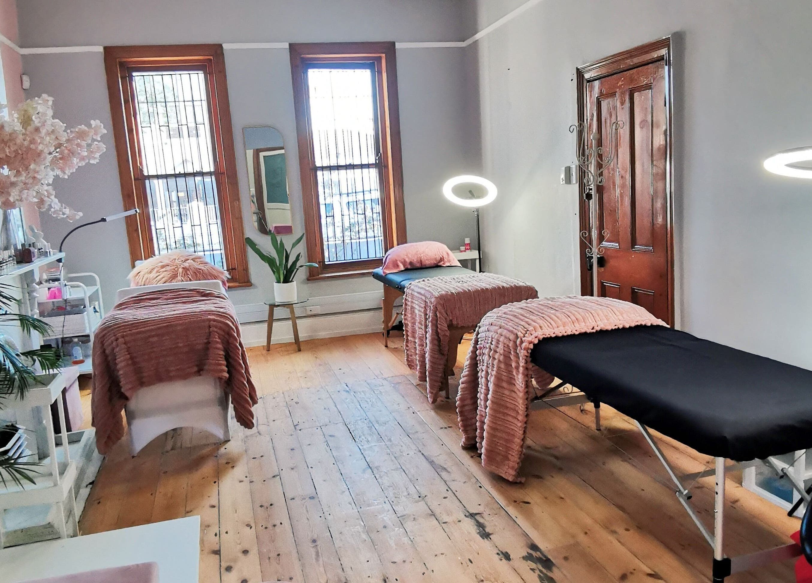 Tranquil treatment room at NovaBelle Beauty, Cape Town, Western Cape, ZA with cozy massage tables and soft lighting.