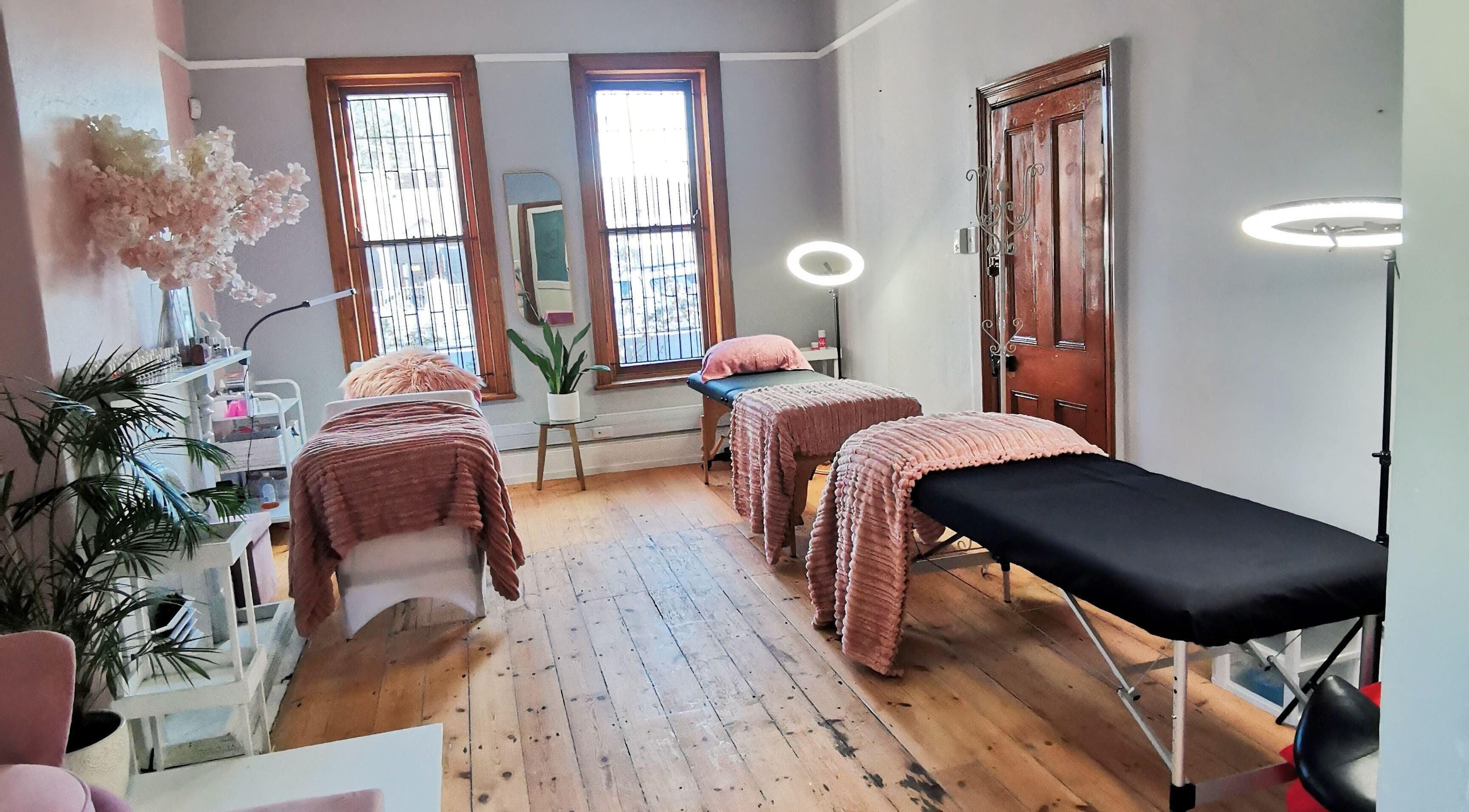 Tranquil treatment room at NovaBelle Beauty, Cape Town, Western Cape, ZA with cozy massage tables and soft lighting.