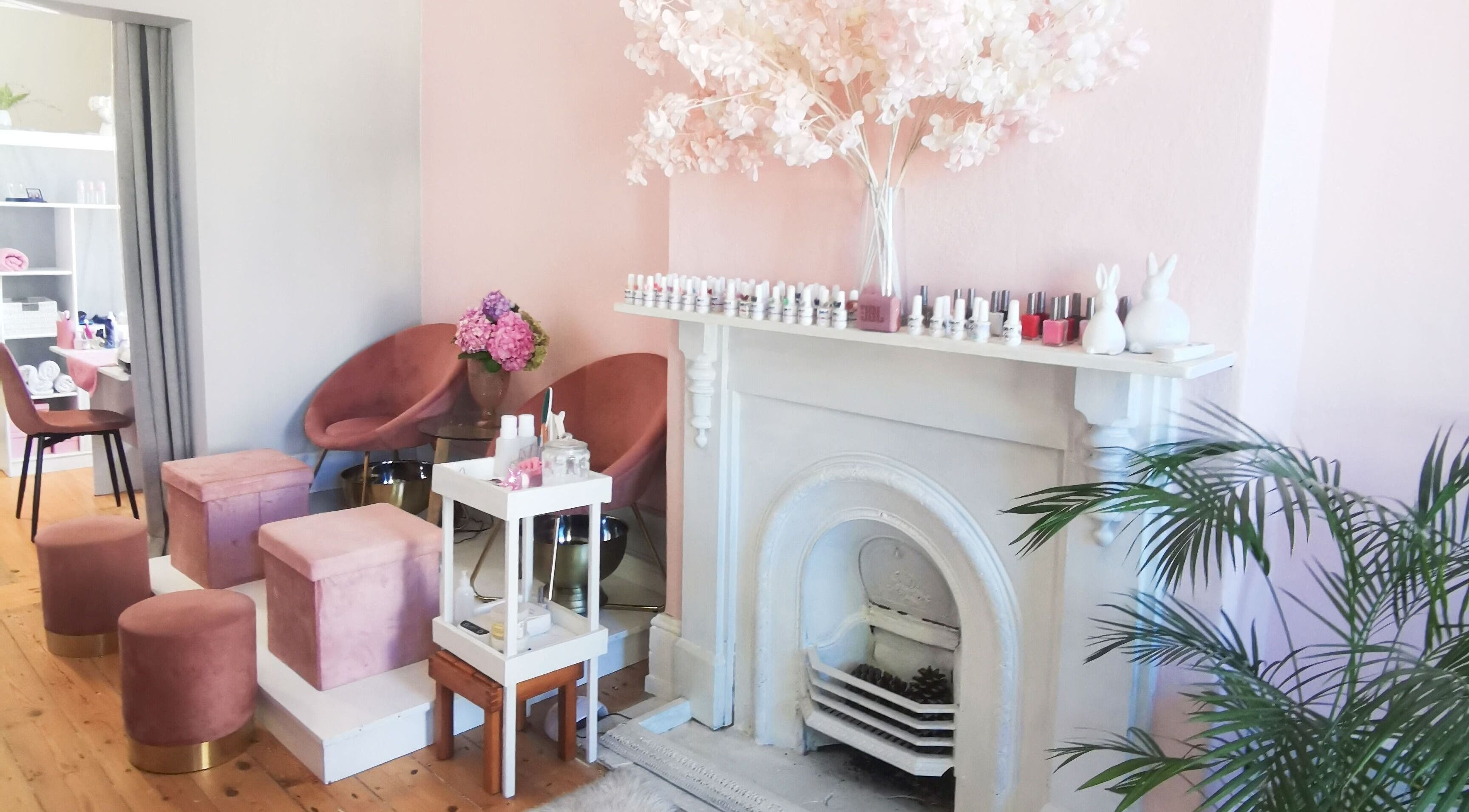 Elegant beauty corner at NovaBelle Beauty, Cape Town, Western Cape, ZA with plush seats and pink hydrangeas.