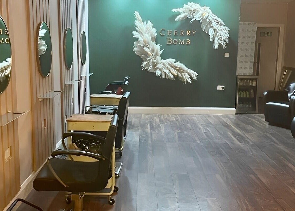 Interior of Cherry Bomb salon in Frodsham, England showing stylish decor and comfortable seating.