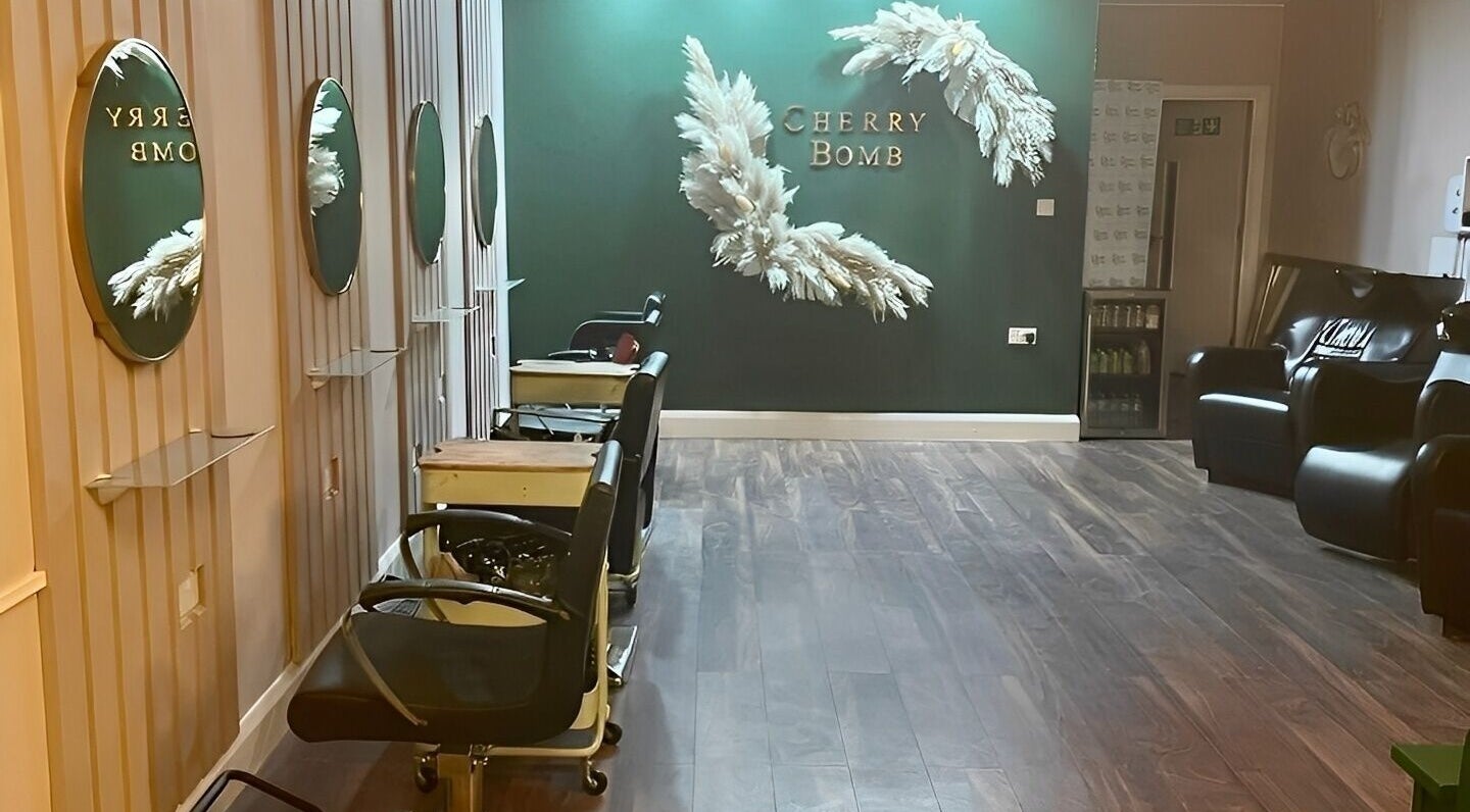 Interior of Cherry Bomb salon in Frodsham, England showing stylish decor and comfortable seating.