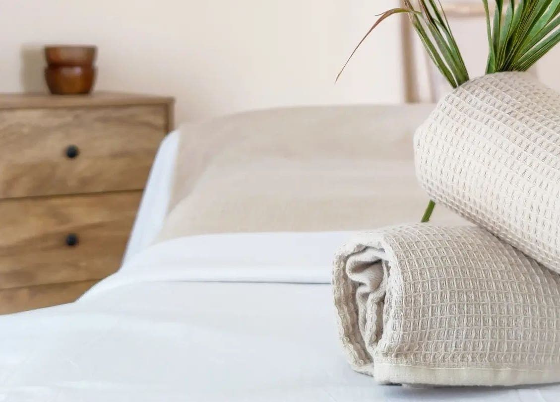 Massage bed with beige towels at Naós Massage and Wellness Studio, Kos, Greece, GR.
