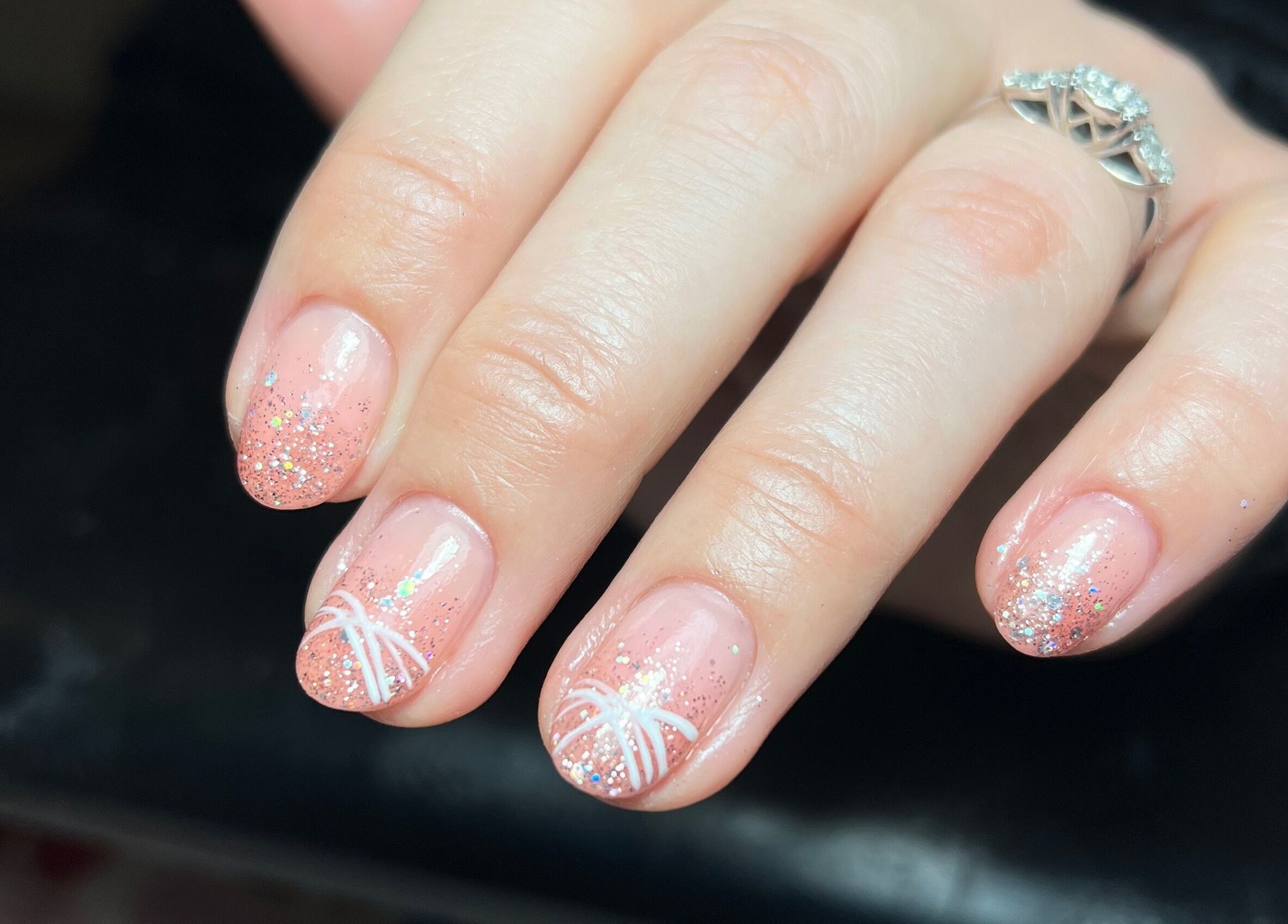 Glittery nail art with white design at The Paint Bar, Brighton And Hove, England, GB.