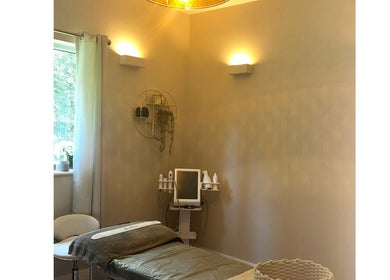 A serene treatment room at L B Aesthetics and Beauty, Ashford, England, GB with cozy ambient lighting.
