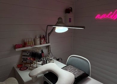 Modern nail studio setup at By Lilly Studio, Wilmslow, England, GB, featuring tools and pink neon sign.
