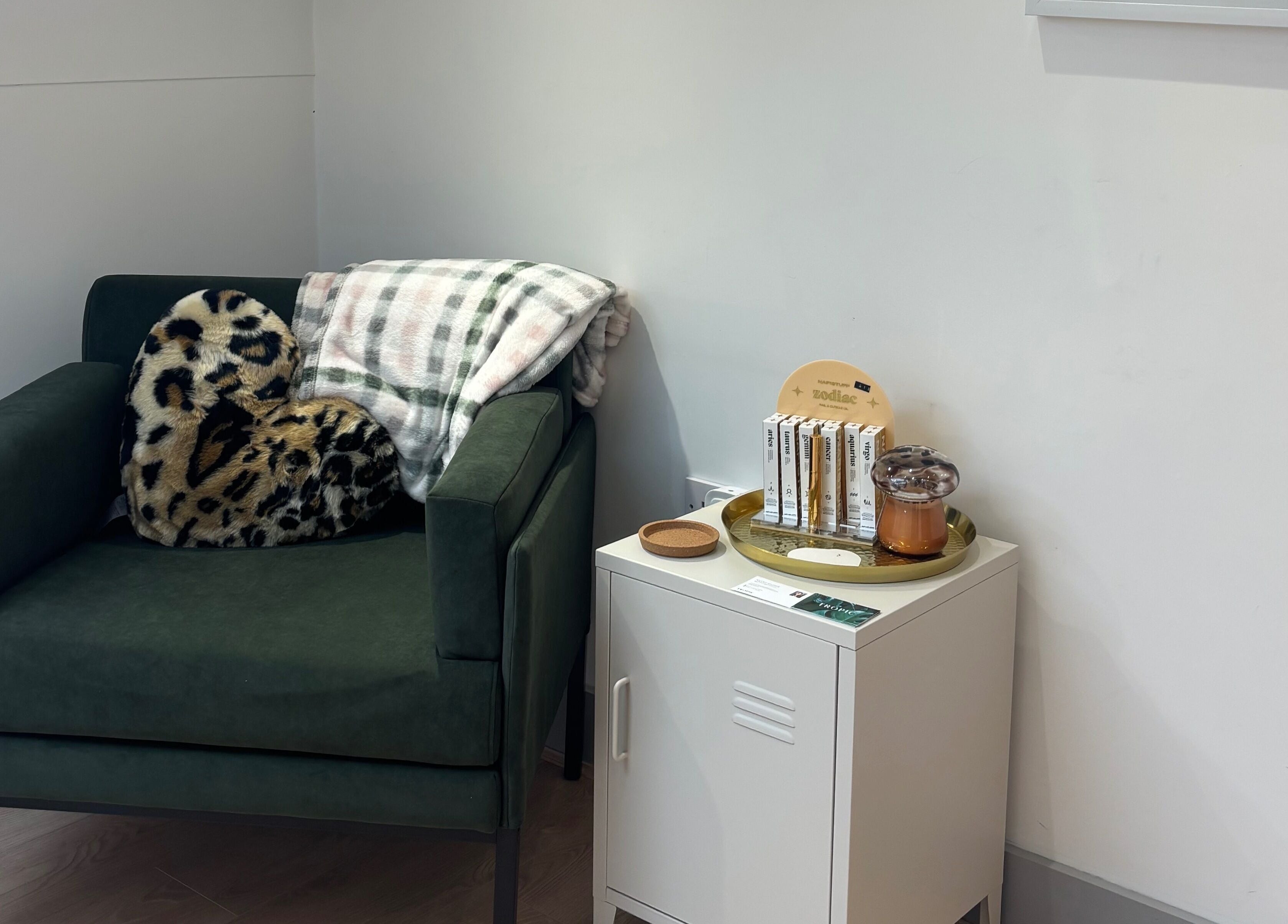 Comfortable green chair with leopard pillow at By Lilly Studio, Wilmslow, England, GB.