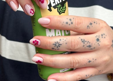 Close-up of floral nail art by By Lilly Studio in Wilmslow, England, GB, showcasing intricate tattoos.