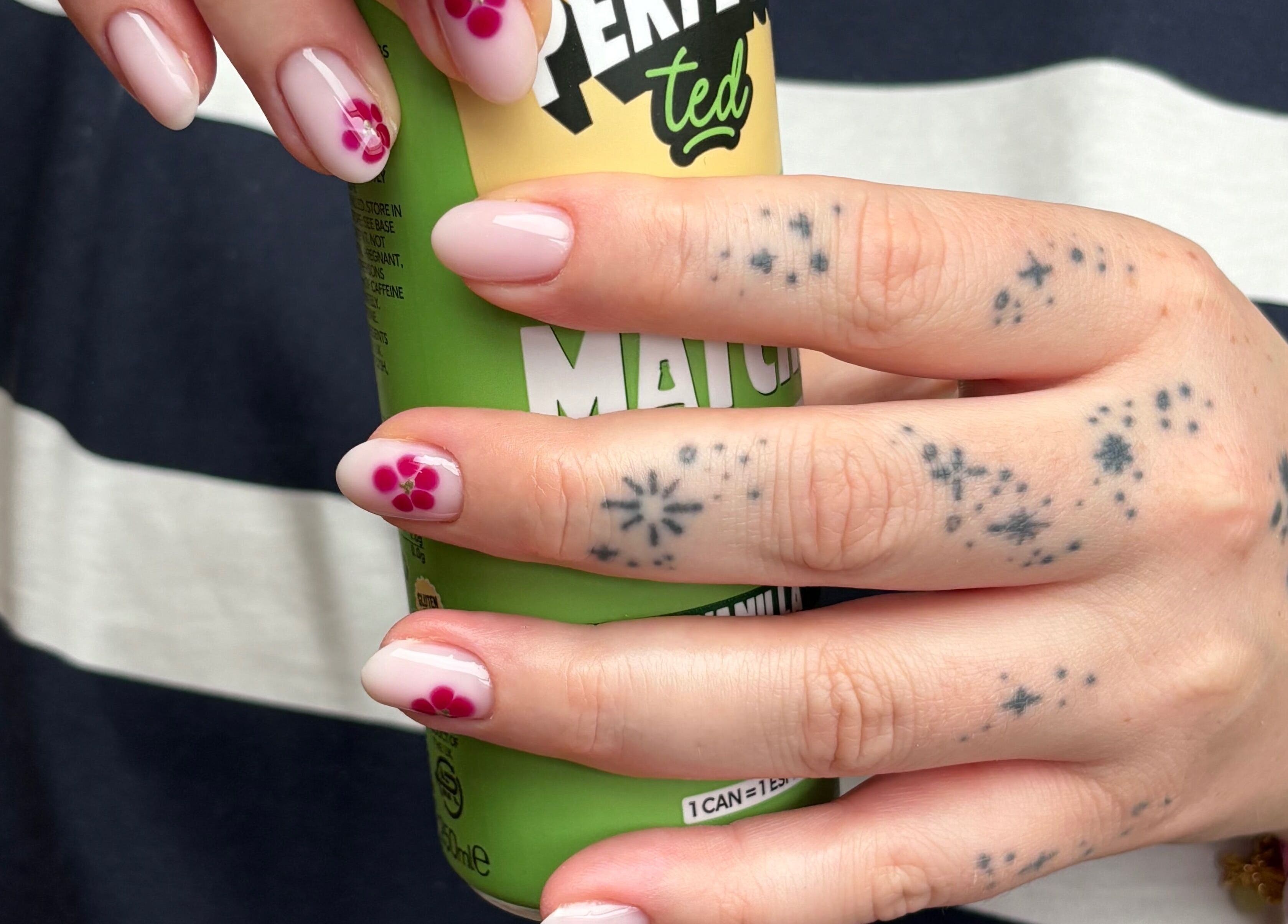 Close-up of floral nail art by By Lilly Studio in Wilmslow, England, GB, showcasing intricate tattoos.