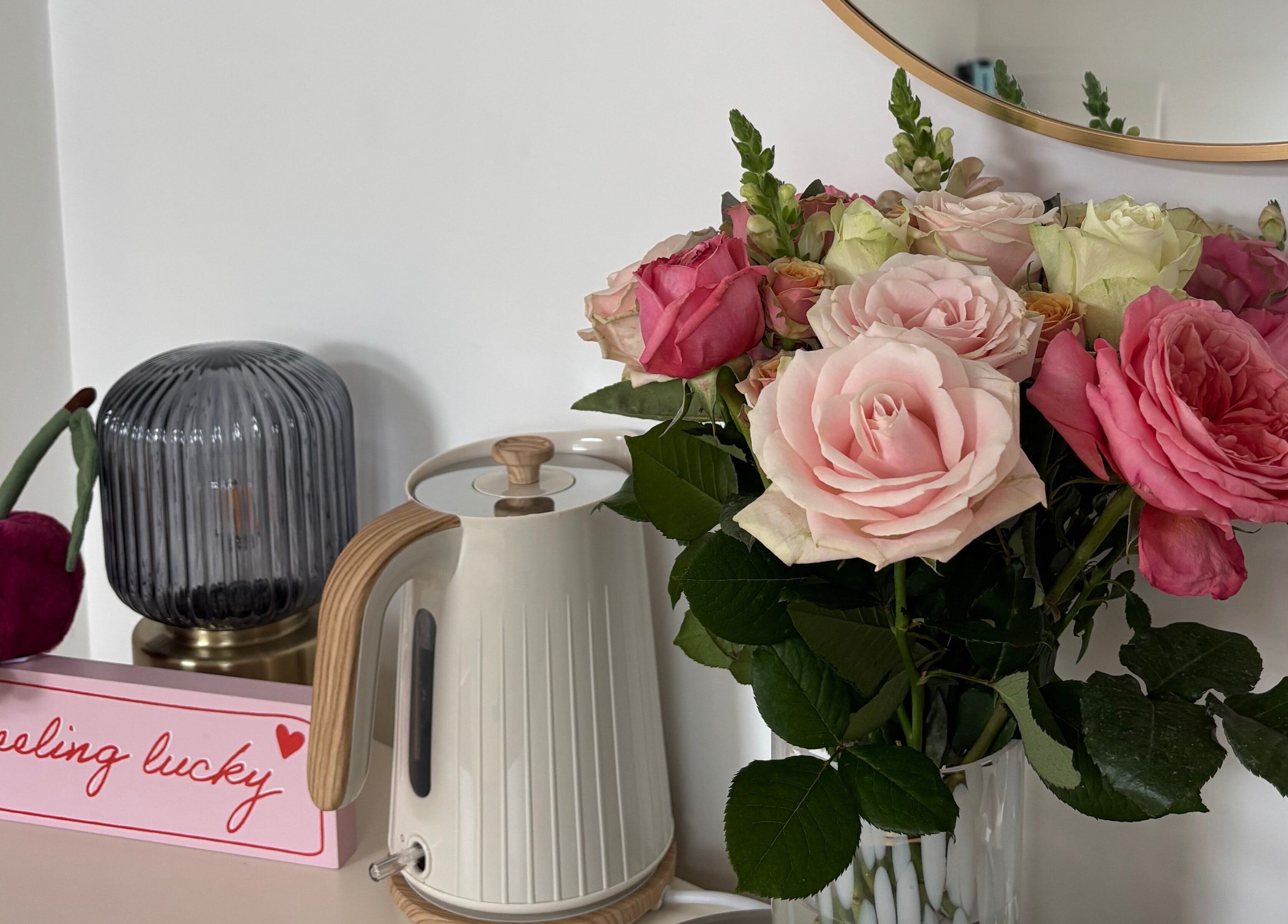 Cozy setup with pink roses, a kettle, and decor at By Lilly Studio, Wilmslow, England, GB.