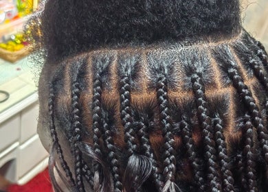 Intricate braiding at Aneric Hair Salon, Johannesburg, Gauteng, ZA, showcasing skilled hairstyling.
