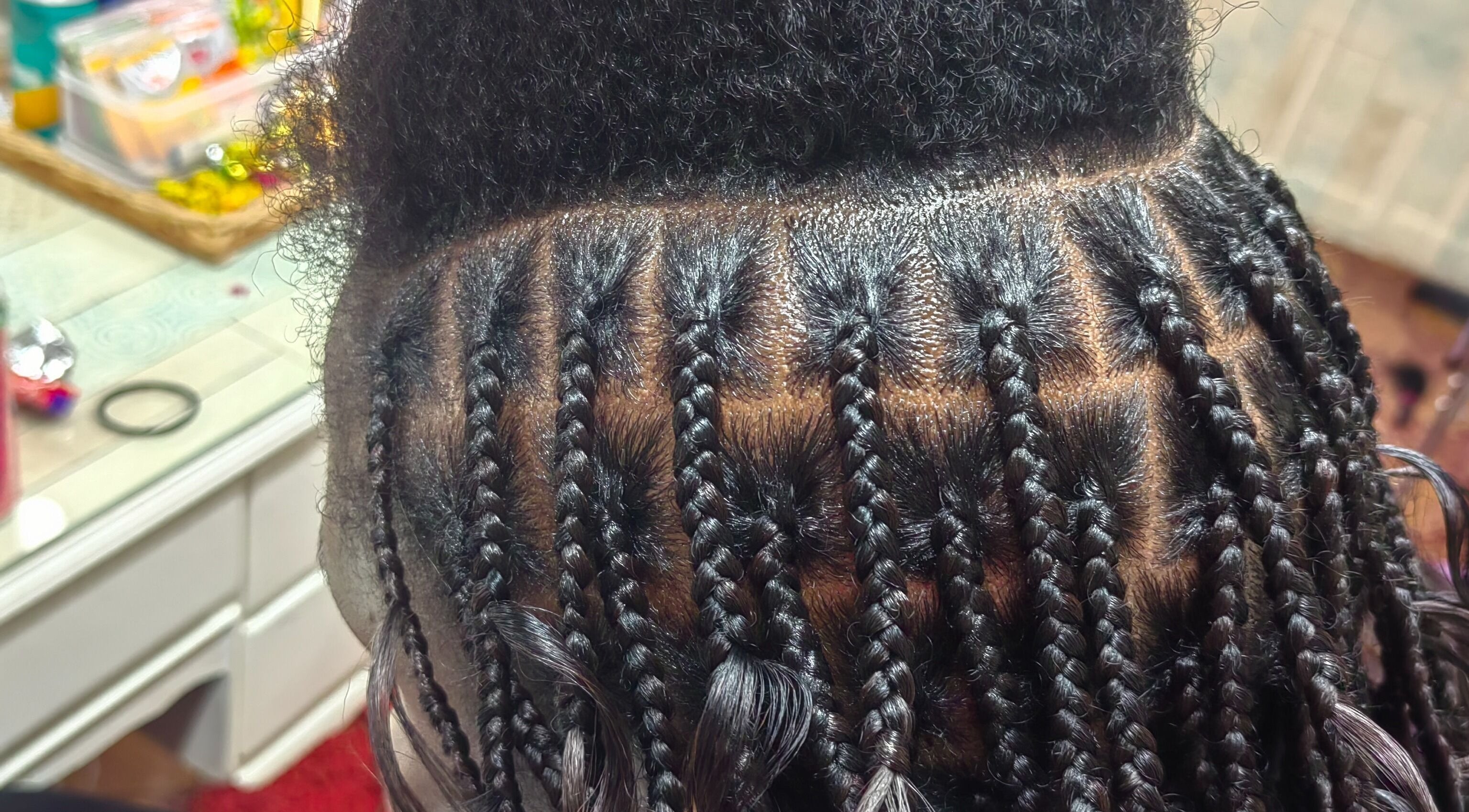 Intricate braiding at Aneric Hair Salon, Johannesburg, Gauteng, ZA, showcasing skilled hairstyling.