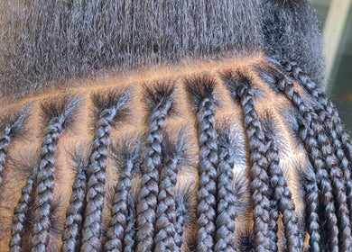 Intricate braiding at Aneric Hair Salon in Johannesburg, Gauteng, ZA showcases detailed hair artistry.