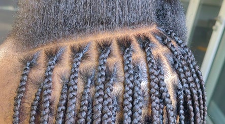 Intricate braiding at Aneric Hair Salon in Johannesburg, Gauteng, ZA showcases detailed hair artistry.