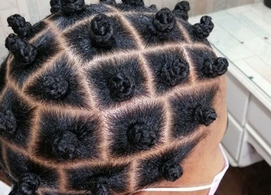 Stylish Bantu knots at Aneric Hair Salon in Johannesburg, Gauteng, ZA showcase intricate hairstyling expertise.
