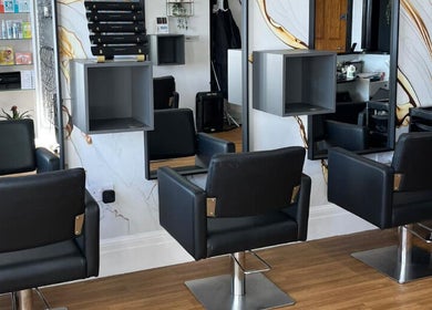 Stylish interior of Hair by Keri Muir, Larbert, Scotland, GB, featuring modern salon chairs and sleek design.